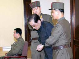 Song Thaek es sostenido por dos militares momentos antes de su ejecución. ARCHIVO /