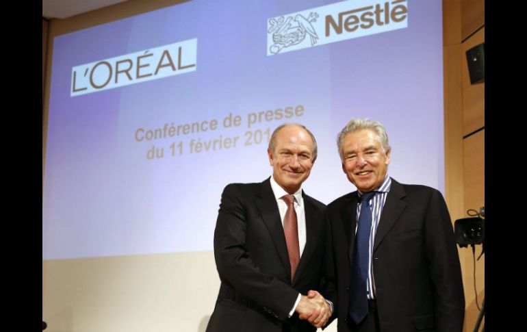 Jean-Paul Agon (i) consejero del grupo de cosméticos y Peter Brabeck-Letmathe, presidente de Nestlé, al firmar el acuerdo. EFE /