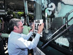 El titular de Movilidad, Mauricio Gudiño, estuvo presente en la pega de calcomanias con la nueva tarifa de seis pesos.  /