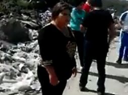 La regidora Nelyda Torres Valencia viste completamente de negro y es acompañada por otras personas. ESPECIAL /