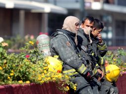Bomberos, visiblemente devastados ante el siniestro.  /