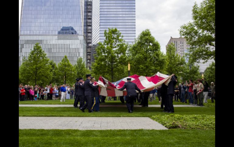 Antes de que el recinto abriera sus puertas al público en general, un grupo de cadetes desplegó la llamada 'bandera nacional del 11-S'. AP /