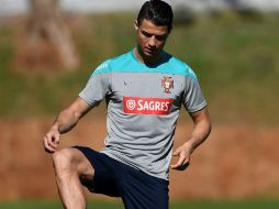 Con una cinta adherida en la rodilla, el portugués se muestra participativo en la práctica matutina. AFP /