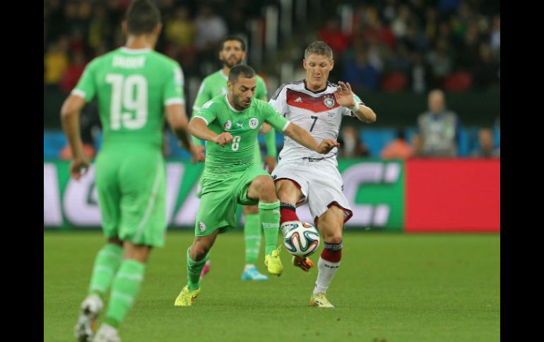 Bastian Schweinsteiger (r) de Alemania, pelea el balón con Djamel Mesbah, de Argelia. EFE /