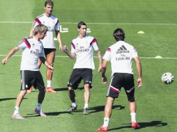 Mientras Cristiano Ronaldo (fondo) se recuperó de sus molestias, Ángel Di María (centro) anunció que se quiere marchar del Madrid. EFE /