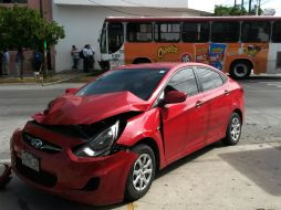 Por el golpe, el auto queda afuera de un comercio y el urbano derriba un semáforo.  /