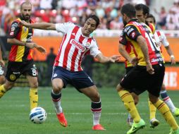 El jugador de Chivas Fernando Arce (c) disputa el balón con Félix Araujo (d) y Marc Crosas (i) de Leones Negros. EFE /