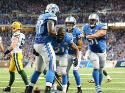 Reggie Bush (#21) celebra con sus compañeros en triunfo de Detroit. AFP  L. Halip.  /