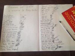 La pequeña toma una hoja y la titula: ''Personas que quieren la renuncia de Peña Nieto''. FACEBOOK / Karina Gidi