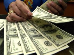El tipo de cambio para solventar obligaciones en moneda extranjera pagaderas es de 14.6359 pesos. AFP / ARCHIVO