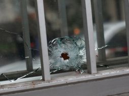Un impacto de bala se ve en una ventana de un edificio al lado de la sede de la publicación satírica francesa ''Charlie Hebdo''. AP / T. Camus