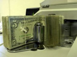 El tipo de cambio para solventar obligaciones en moneda extranjera pagaderas es de 14.5559 pesos. AP / ARCHIVO