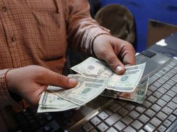 El tipo de cambio para solventar obligaciones en moneda extranjera pagaderas en la República Mexicana es de 14.9885 pesos. EL INFORMADOR / ARCHIVO