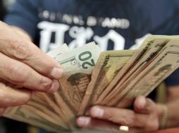 El Banxico señaló que el tipo de cambio para solventar obligaciones en moneda extranjera es de 14.9862 pesos. EL INFORMADOR / ARCHIVO