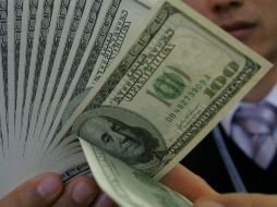 El tipo de cambio para solventar obligaciones en moneda extranjera pagaderas en el país es de 14.9544 pesos. EL INFORMADOR / ARCHIVO