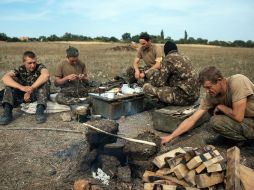 Soldados ucranianos se preparan una comida en una fogata en su campamento militar. EFE / ARCHIVO