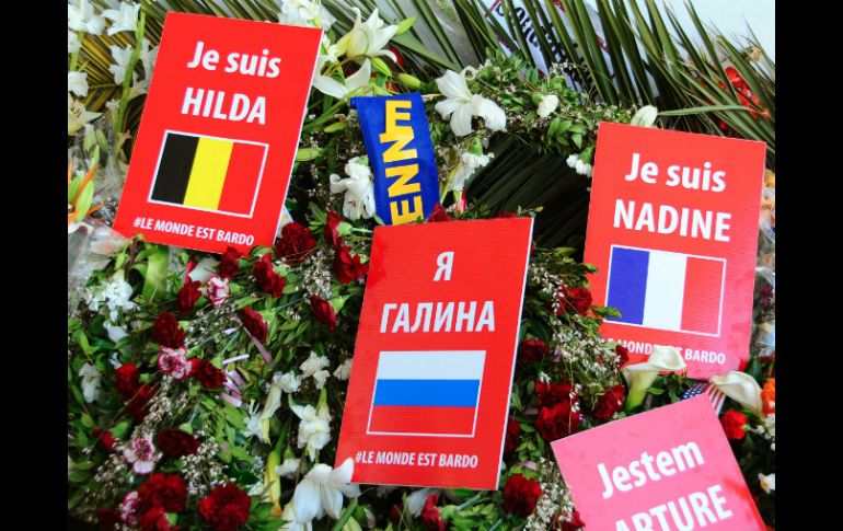 Un flujo pequeño y constante de visitantes caminó frente a flores dejadas en honor de las víctimas y banderas de sus nacionalidades. AP / H. Dridi