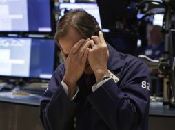 El selectivo S&P, que este jueves alcanzó su décimo récord histórico en lo que va del año, tampoco se salvó del retroceso. AP / R. Drew