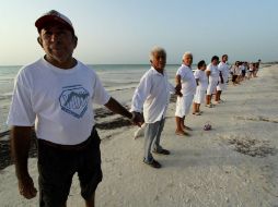 Poco más de 200 personas, en su mayoría vestidas de blanco, se enlazaron físicamente en Playa San Thelmo, en la isla de Holbox. NTX / F. Gálvez