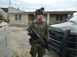 Un soldado permanece en guardia, afuera de la casa donde se encuentra el final del túnel por el que huyó el ''Chapo'' Guzmán. AFP / Y. Cortez