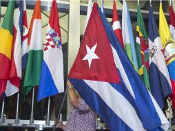 Un trabajador del Departamento de Estado coloca la bandera cubana en el recibidor de la sede diplomática. AFP / P. Richards