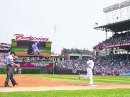 Addison Russell (#22) de los Cachorros de Chicago avanza a home en el Wrigley Field de Chicago. AFP / J. Daniel
