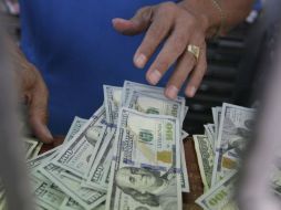 El tipo de en moneda extranjera pagaderas en el país se fijó en 16.4196 pesos, informó Banxico. EL INFORMADOR / ARCHIVO