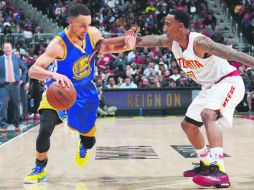 Philips Arena. La estrella de los Warriors de Golden State, Stephen Curry (izq.), encara a Jeff Teague, de Atlanta. AP / M. Blinch