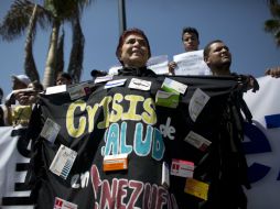 La marcha estuvo fuertemente custodiada por policías y guardias nacionales. AP / A. Cubillos