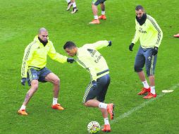 Cristiano Ronaldo enfrenta a Pepe durante el entrenamiento de ayer. Benzema observa la acción. EFE /