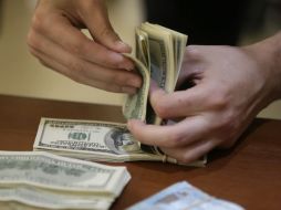 Banco Base estima que este lunes el tipo de cambio podría cotizar entre 18.50 y 18.70 pesos por dólar. AP / ARCHIVO