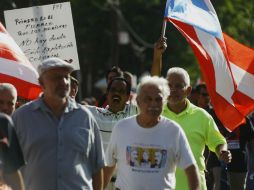 Cientos de puertorriqueños están en desacuerdo por el proyecto 'Promesa', firmado el día de hoy jueves por el presidente Barack Obama. EFE / T. Llorca
