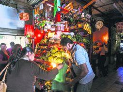 Los locatarios del Mercado Lázaro Cárdenas tuvieron que improvisar con lámparas de pilas y velas para iluminar sus locales. EL INFORMADOR / E. Barrera