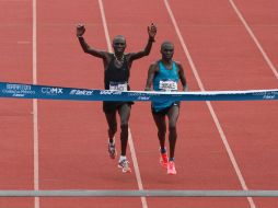 Mnangat (d) arriba a la meta junto a su compatriota y ganador de la edición de 2011, Isaack Kemboii. EFE / M. Guzmán