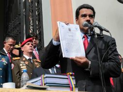 Maduro firmó el presupuesto fiscal frente a cientos de sus partidarios y acompañado de los miembros de su gabinete. AFP / Y. Montes