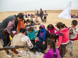 Desde lejos son pequeñas manchas que se mueven. Cuando se vislumbra la bandera blanca, se ve que son civiles que huyen de Mosul. NTX / L. Pistone