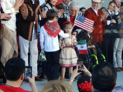 Niños intercambian banderas en la línea fronteriza. SUN / L. Fierro