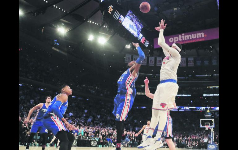 Puntería. Con la marca de Robert Covington (centro), Anthony hizo el enceste del triunfo. AP / J. Jacobson