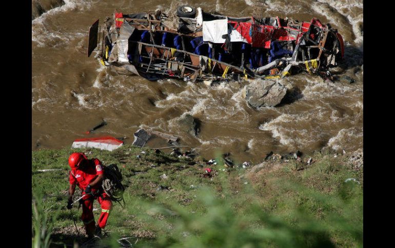 Cuerpos policiacos y bomberos trabajan en el lugar para rescatar los cuerpos de las víctimas que cayeron cerca del río Chalhuanca. EFE / ARCHIVO