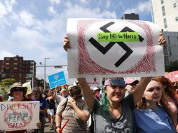 Los participantes muestran carteles con frases como ''Amemos al prójimo'' y ''El odio nunca hizo grande a Estados Unidos''. AFP / S. Platt