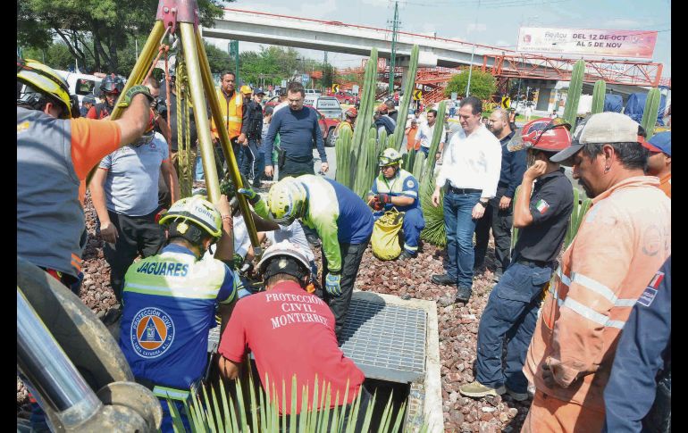 Elementos de Protección Civil de Nuevo León, durante la recuperación del cuerpo de la mujer desaparecida tras caer a un socavón. SUN