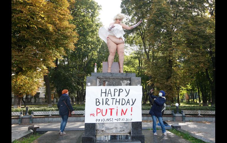 Una mujer en topless representa a Marilyn Monroe en el pedestal del antiguo monumento a los héroes de la revolución de Octubre en Kiev. EFE/S. Franko