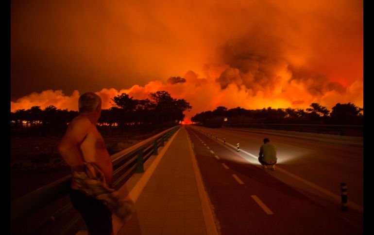 Habitantes de Praia da Vieira observan el avance de las llamas. Según el balance de la Protección Civil lusa, hoy se ha vivido la peor jornada del año en Portugal en cuanto a incendios forestales: 443 fuegos desde la pasada medianoche.