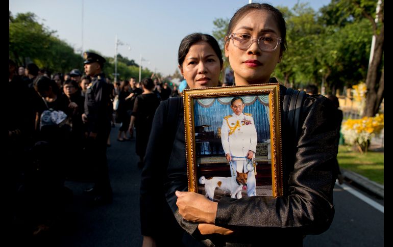 Una mujer carga un retrato del rey tailandés Bhumibol Adulyad en Bangkok, durante el funeral del monarca fallecido el 13 de octubre de 2016.