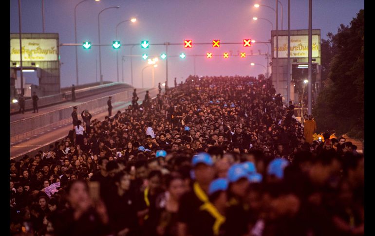 Habitantes aguardan el paso de la procesión. Más de 300 mil tailandeses se concentraron, según las autoridades, a lo largo del trazado de la ceremonia funeraria.