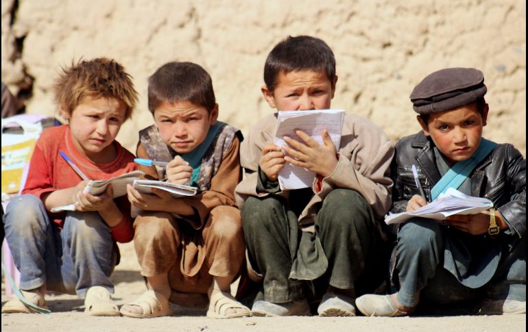 Un grupo de niños afganos hace deberes en el patio de su escuela en Badakhshan. EFE/S. Shayaq
