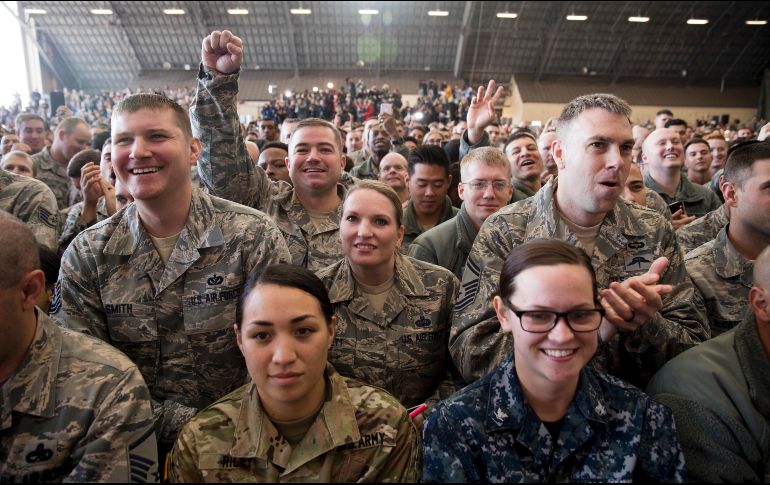 Los miembros de la audiencia miran mientras el presidente Donald Trump habla en un mitin. AP/A. Harnik