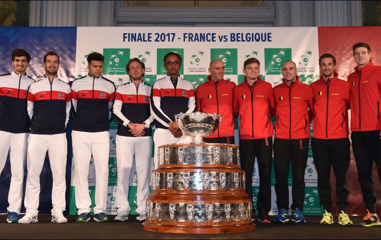 Los equipos de Francia (izquierda) y Bélgica posan junto al trofeo que se llevará el campeón. AFP/P. Huguen