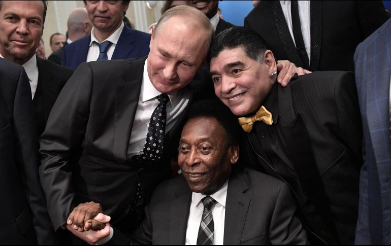 El presidente ruso, Vladimir Putin, toma de la mano a Pelé y del cuello a Maradona, dos de las máximas figuras que ha dado el futbol. AFP/A. Nikolsky