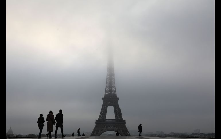 La torre Eiffel se ve entre la niebla en París, Francia. AFP/L. Marin